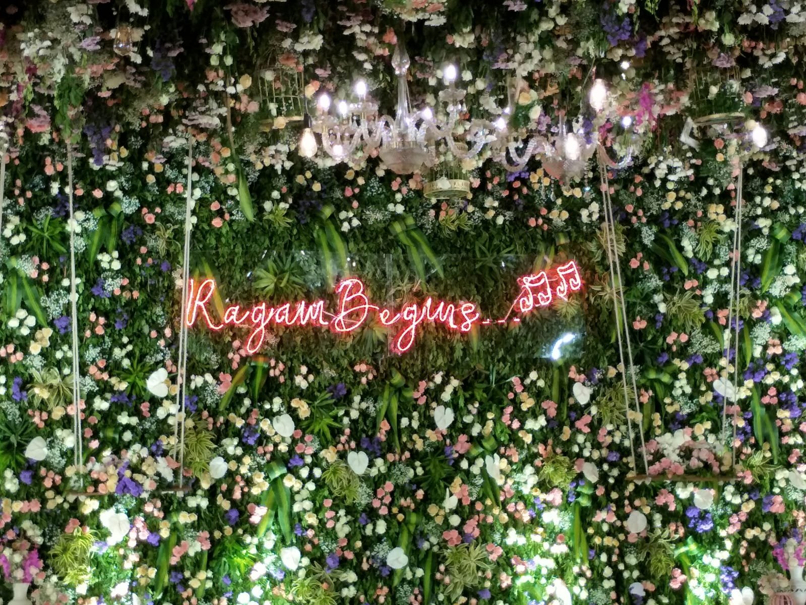 Neon sign on flower wall backdrop
