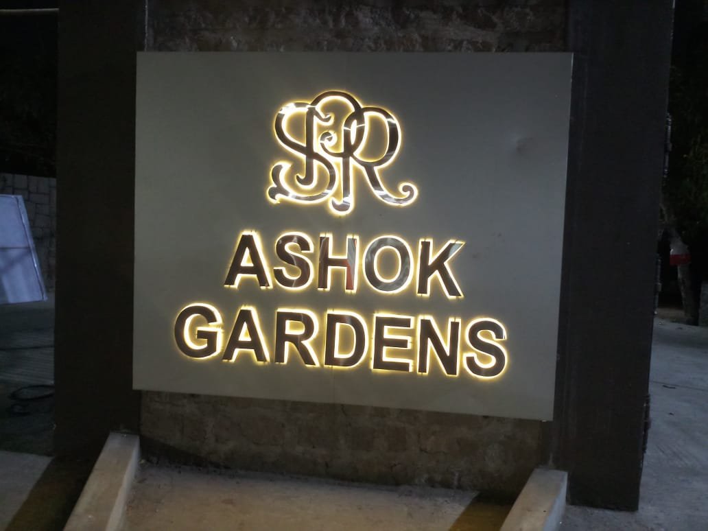Gold backlit monogram signage