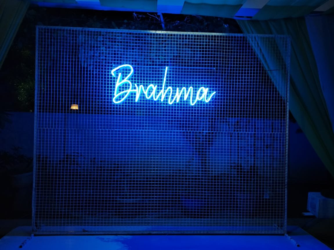 Blue neon sign on mesh wall
