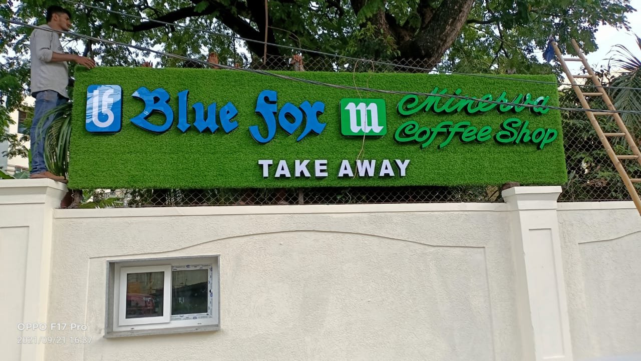 Green artificial turf storefront sign